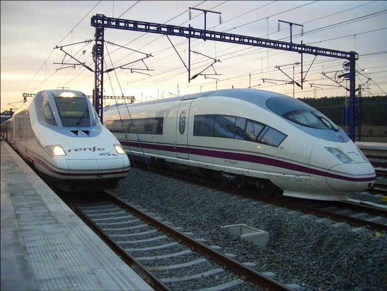 Two high speed trains next to each other.